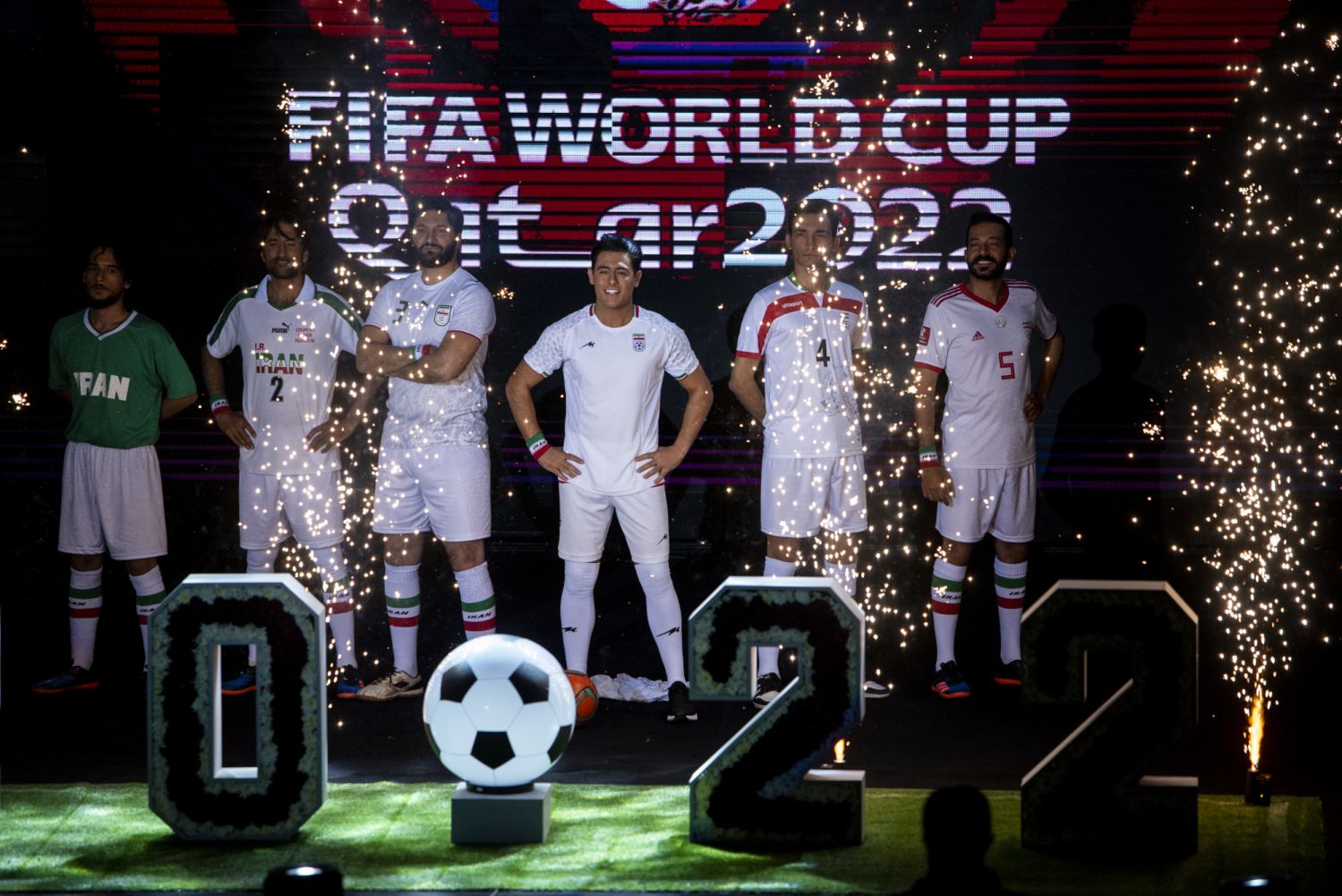 TEHRAN, IRAN - 2022/11/08: A model wears the Iranian national soccer team's new kit, third right, for the upcoming 2022 World Cup in a presentation ceremony in Tehran. Iran plays England in its opening match in Qatar on November 21 before also facing Wales and the United States in Group B. (Photo by Sobhan Farajvan/Pacific Press/LightRocket via Getty Images)