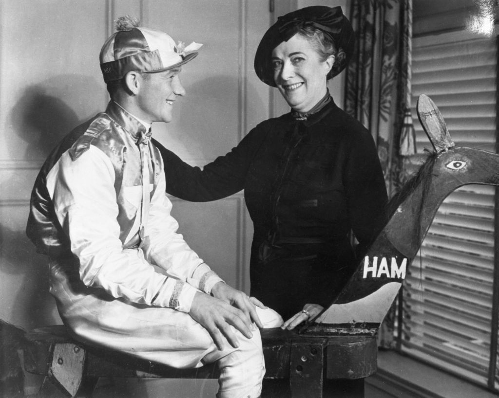 Ethel V. Mars of Indianapolis, owner of the famous Milky Way Stables, with thirty five thoroughbreds at Santa Anita, California, poses with her jockey, A. Robertson.  They attended the annual "Santa Anita Morning" program of the Los Angeles Breakfast Club.  (Photo by Bettmann Archive/Getty Images)