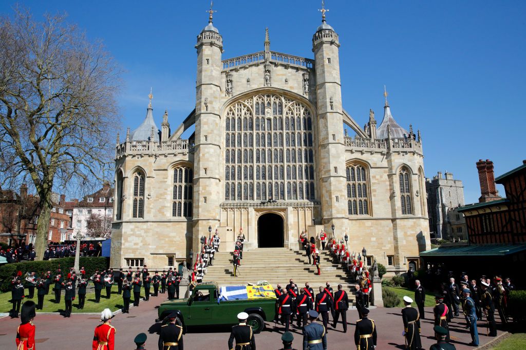 WINDSOR, UNITED KINGDOM - APRIL 17: (EMBARGOED FOR PUBLICATION IN UK NEWSPAPERS UNTIL 24 HOURS AFTER CREATE DATE AND TIME) Prince Philip, Duke of Edinburgh's coffin (draped in his Royal Standard Flag and bearing his Royal Navy cap, sword and a bouquet of lilies, white roses, freesia and sweet peas) is carried on a specially designed Land Rover Defender hearse to his funeral service at St. George's Chapel, Windsor Castle on April 17, 2021 in Windsor, England. Prince Philip of Greece and Denmark was born 10 J