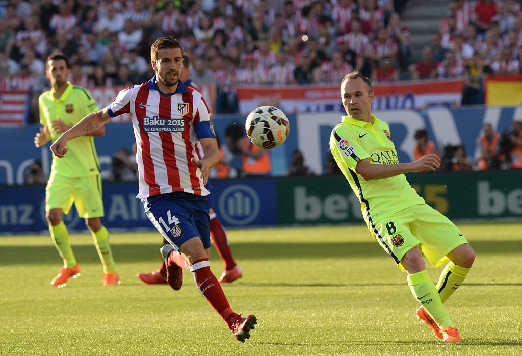 MADRID, SPAIN - MAY 17: Andrés Iniesta Luján of Barcelona (R) in action against Gabi (L) of Atletico Madrid during the La Liga match between Club Atletico de Madrid and FC Barcelona at Vicente Calderon Stadium on May 17, 2015 in Madrid, Spain. (Photo by Evrim Aydin/Anadolu Agency/Getty Images)
