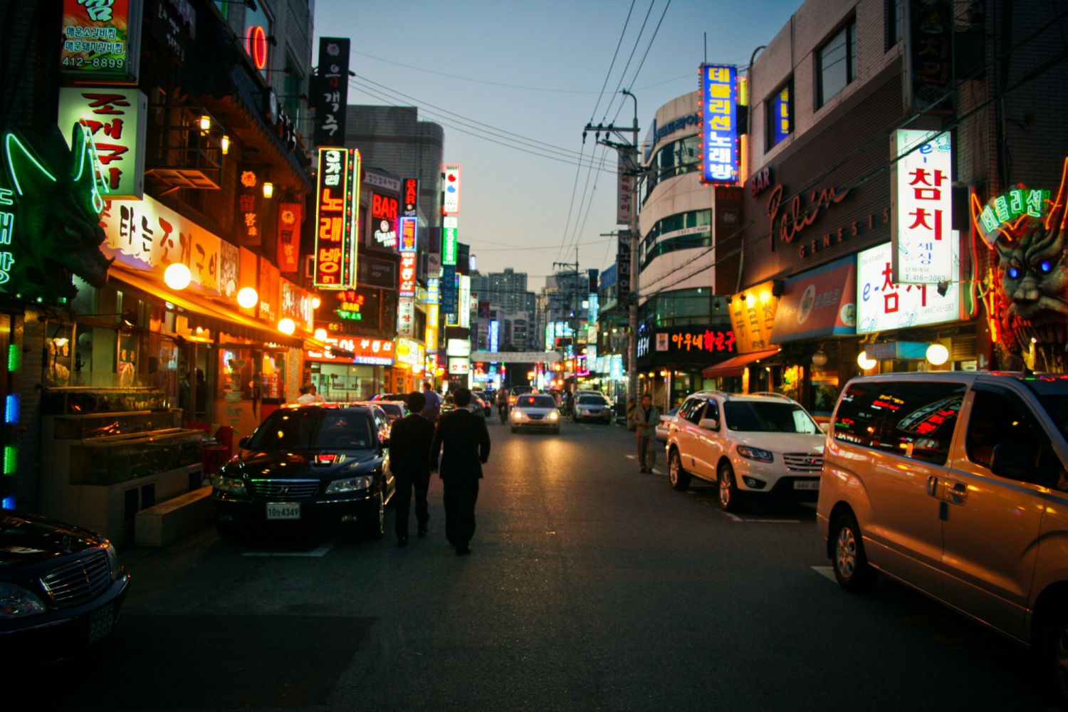 Lit up shops, restaurants and bars on road in Bangi-dong, Seoul, Korea.