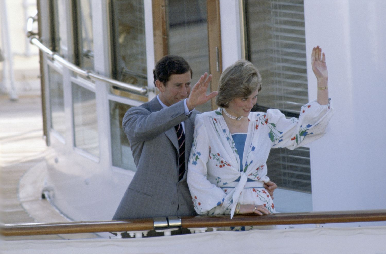 GIBRALTAR - AUGUST 01: Prince Charles With His Arm Around Princess Diana At The Rail Of The Royal Yacht Britannia At The Start Of Their Honeymoon Cruise.her Outfit Designed By Donald Campbell (Photo by Tim Graham Photo Library via Getty Images)