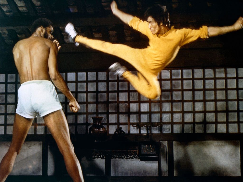 American actor Kareem Abdul-Jabbar and Chinese American martial artist and actor Bruce Lee on the set of 'Game of Death', written and directed by Robert Clouse, 1972. (Photo by Concord Productions Inc./Golden Harvest Company/Sunset Boulevard/Corbis via Getty Images)