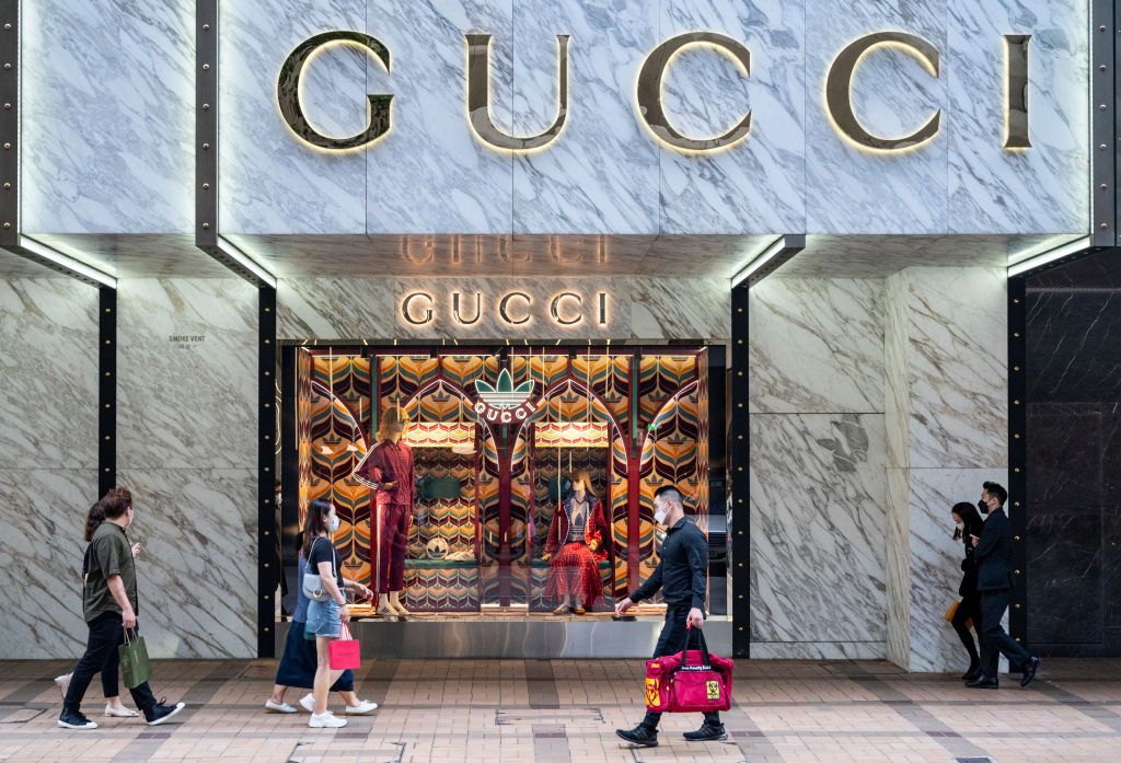 HONG KONG, CHINA - 2022/06/29: Shoppers walk past the Italian luxury fashion brand Gucci logo and store in Hong Kong. (Photo by Budrul Chukrut/SOPA Images/LightRocket via Getty Images)