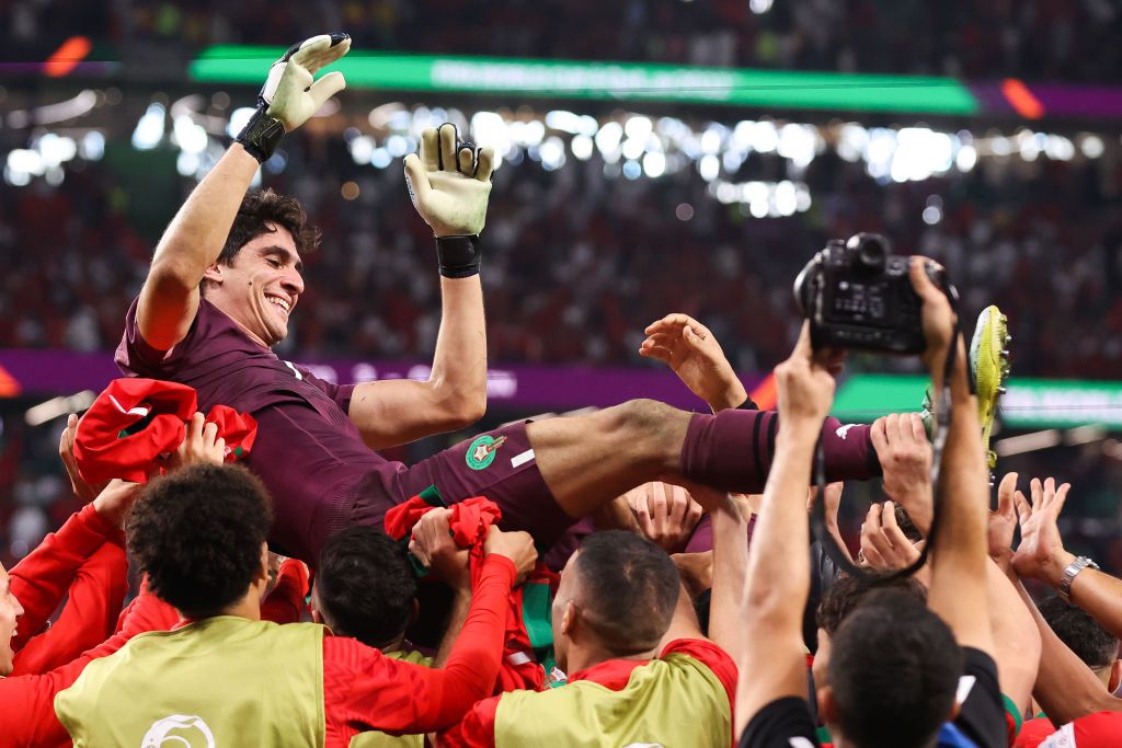 AL RAYYAN, QATAR - DECEMBER 06: Yassine 'Bono' Bounou of Morocco is thrown in the air by his teammates after the penalty shootout during the FIFA World Cup Qatar 2022 Round of 16 match between Morocco and Spain at Education City Stadium on December 06, 2022 in Al Rayyan, Qatar. (Photo by Alex Livesey - Danehouse/Getty Images)