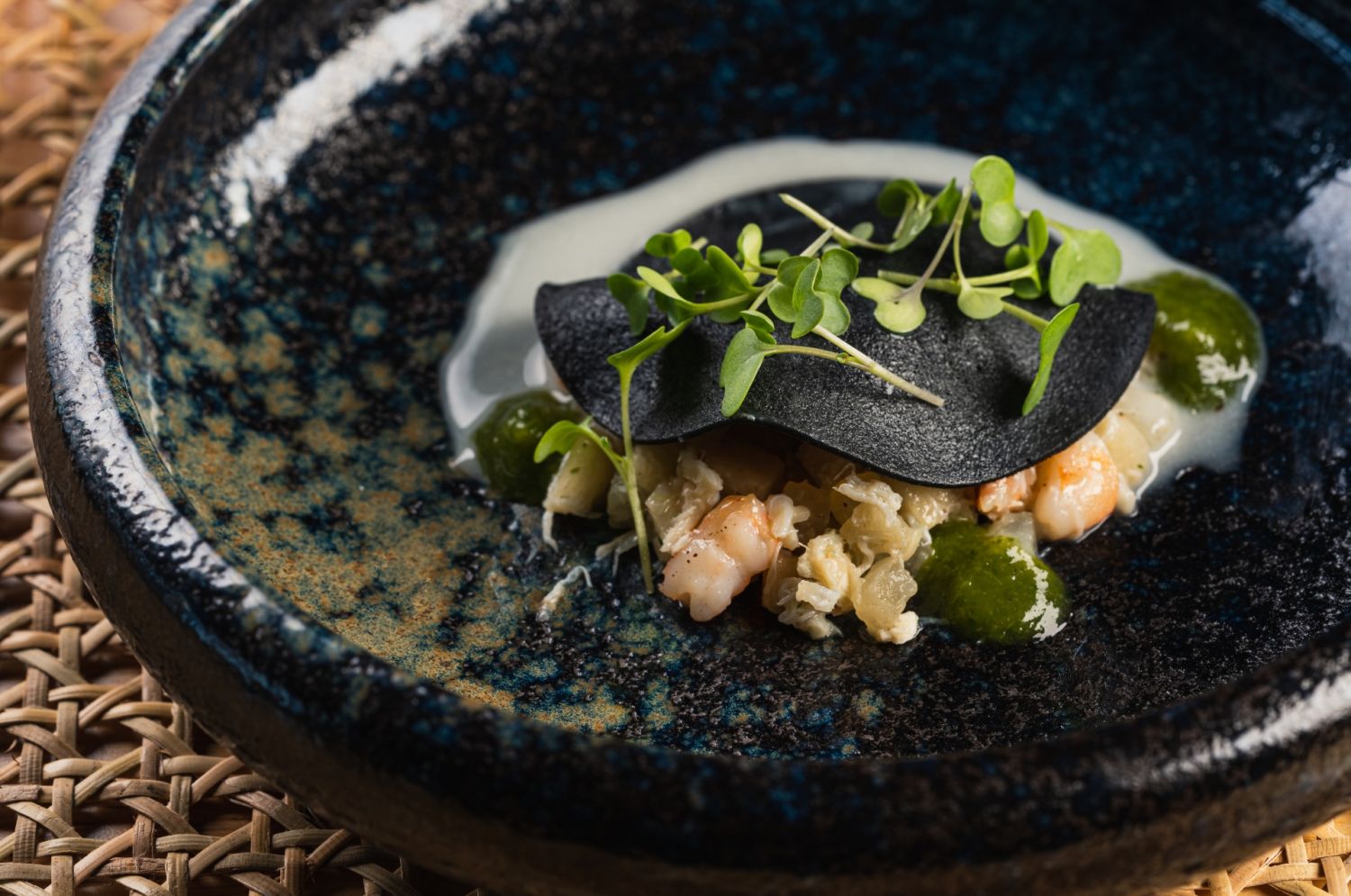 Lumpia fresca: shrimp, crab meat and turnip beneath a blanket of squid ink crepe with white garlic sauce and cilantro gel