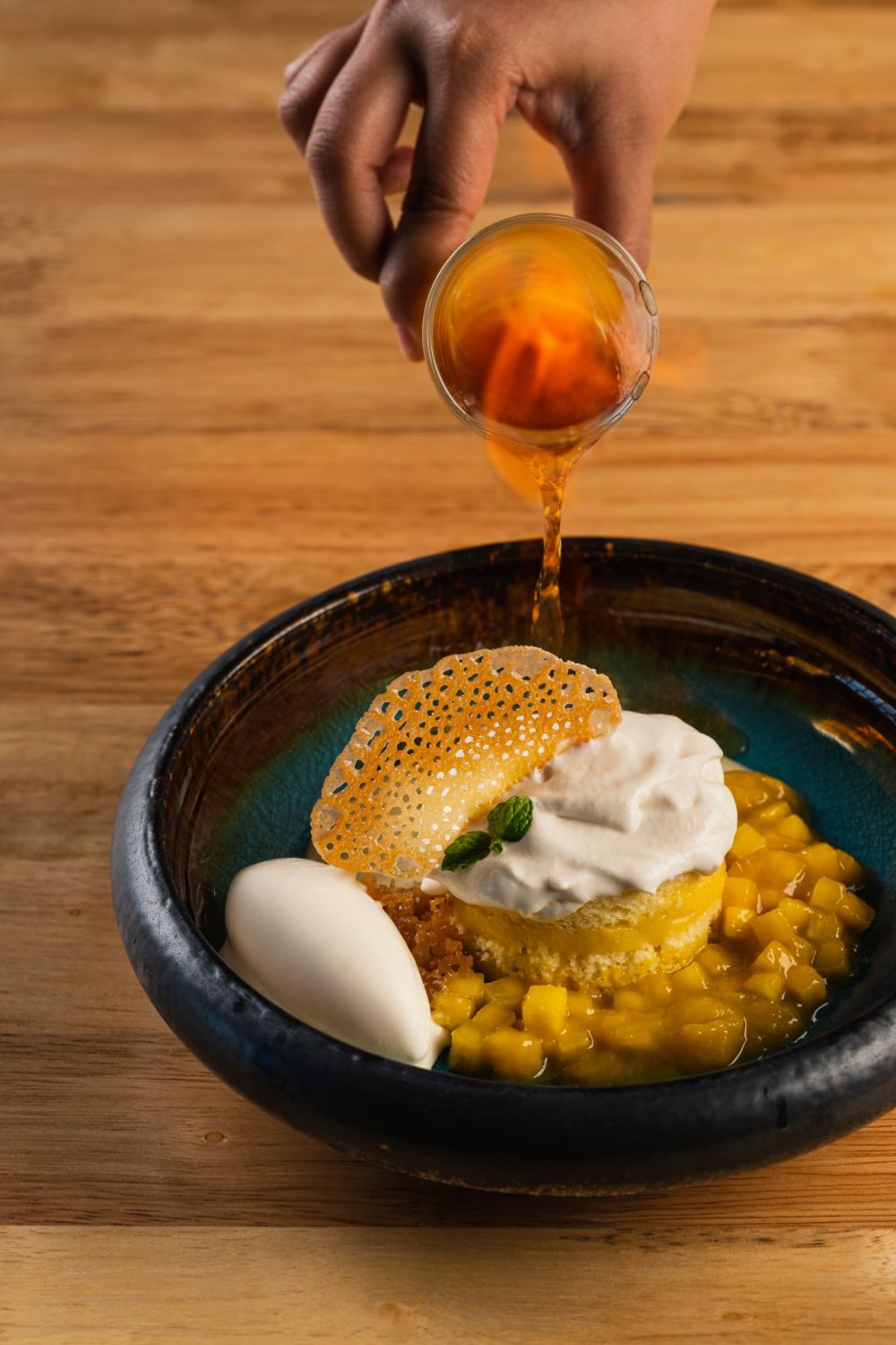 Mango jubilee: sponge cake drenched in Tres Leches with flambéed mango, lemon sabayon, and vanilla ice cream