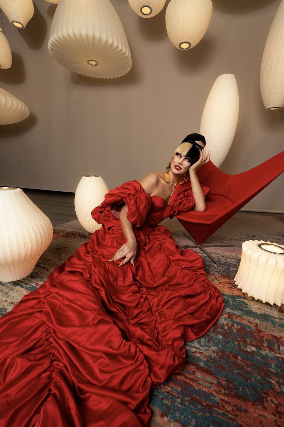 Luzon beside the Heart Cone chair by Vitra (CWC Interiors), wearing a Fred Telarma gown and jewellery by Farah Abu, KATAW, B.O.G. Fine Jewelry and Thingamabobs Art Jewelry