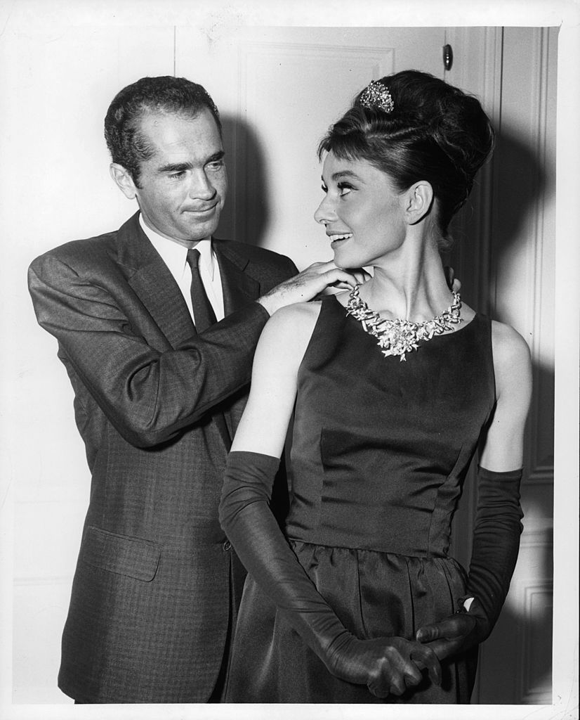 Henry B Platt, great-grandson of the founder of Tiffany's, adjusts Audrey Hepburn's necklace to signal the start of production for the film 'Breakfast At Tiffany's', 1961. (Photo by Paramount/Getty Images)