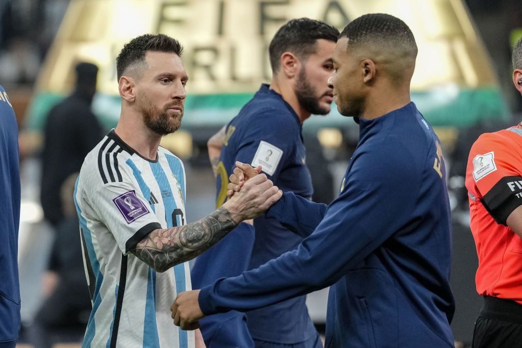 LUSAIL CITY, QATAR - DECEMBER 18: Lionel Messi of Argentina and Kylian Mbappe of France shake hands prior to the FIFA World Cup Qatar 2022 Final match between Argentina and France at Lusail Stadium on December 18, 2022 in Lusail City, Qatar. (Photo by Mohammad Karamali/Defodi Images via Getty Images)