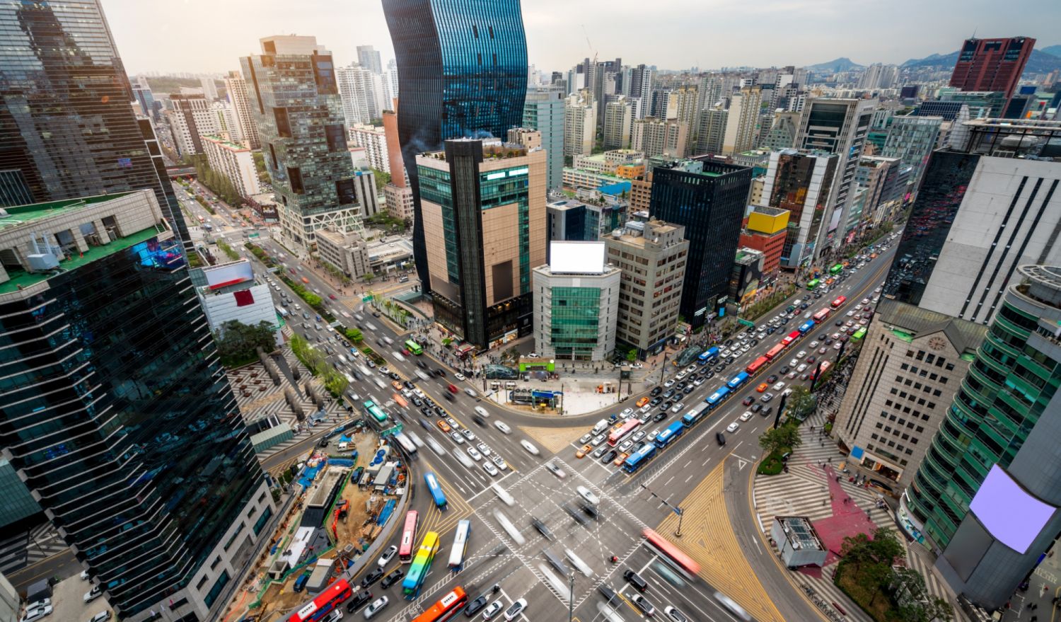 Sunset scene of light trails traffic speeds through an intersection in Gangnam center business district of Seoul at Seoul city, South Korea.