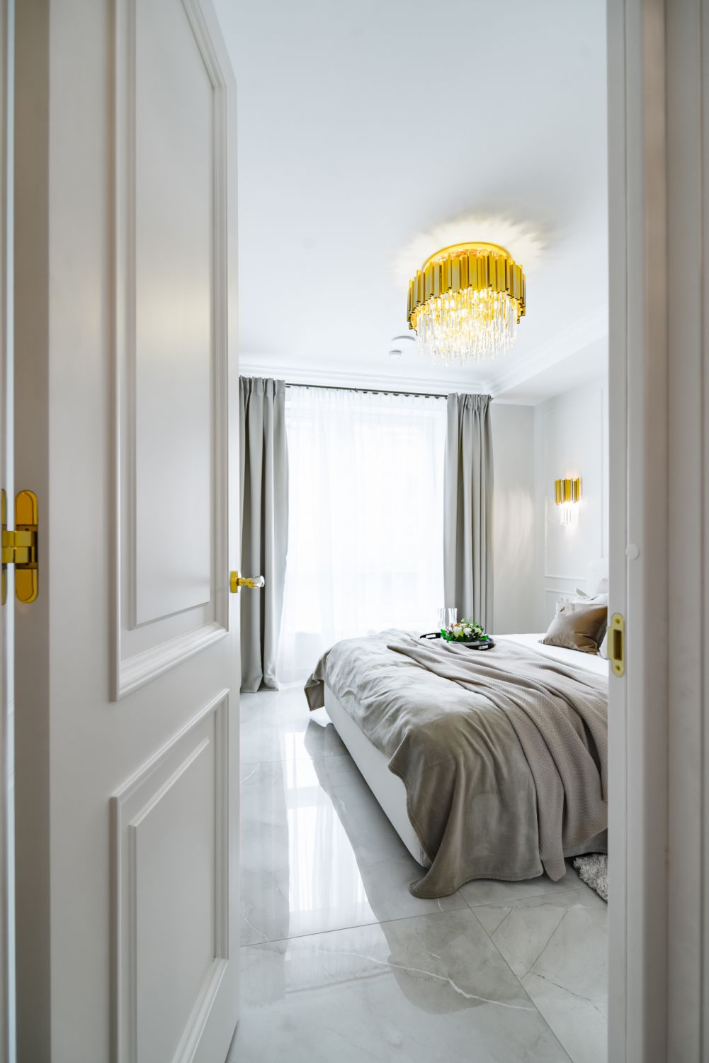 View through the bedroom door to kingsize bed in bright and cozy bedroom.