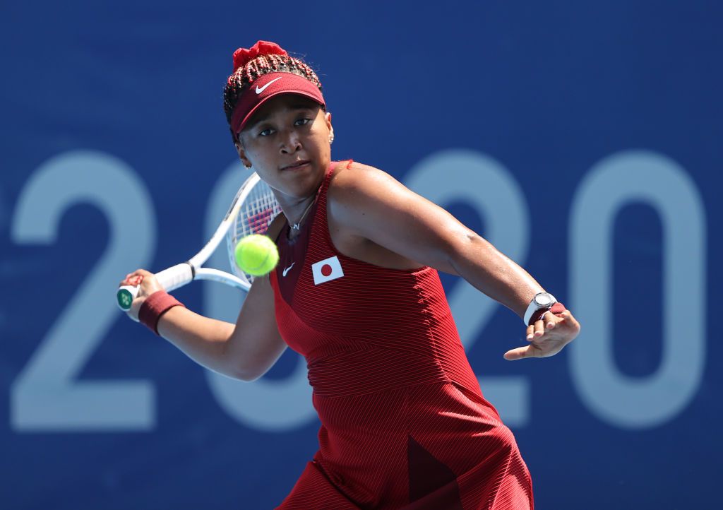 TOKYO, JAPAN - JULY 25: Naomi Osaka of Team Japan plays a forehand during her Women's Singles First Round match against Saisai Zheng of Team China on day two of the Tokyo 2020 Olympic Games at Ariake Tennis Park on July 25, 2021 in Tokyo, Japan. (Photo by Clive Brunskill/Getty Images)