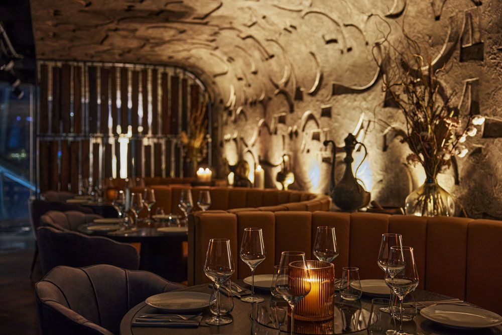 Booth seats with symbols carved into the walls