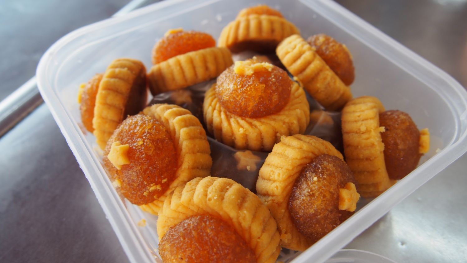 Pineapple tart in an open plastic container