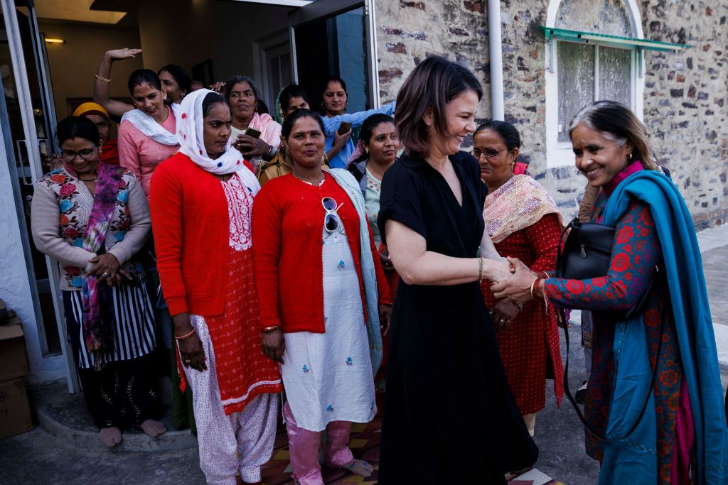06 December 2022, India, Khori: Annalena Baerbock (Bündnis 90/ Die Grünen), Federal Minister for Foreign Affairs, meets with women of the village of the project "Social Center for Rural Initiative and Advancement". In this village, projects on renewable energies and rainwater storage are implemented. It is the last item on the program of a two-day trip to India. Photo: Carsten Koall/dpa (Photo by Carsten Koall/picture alliance via Getty Images)