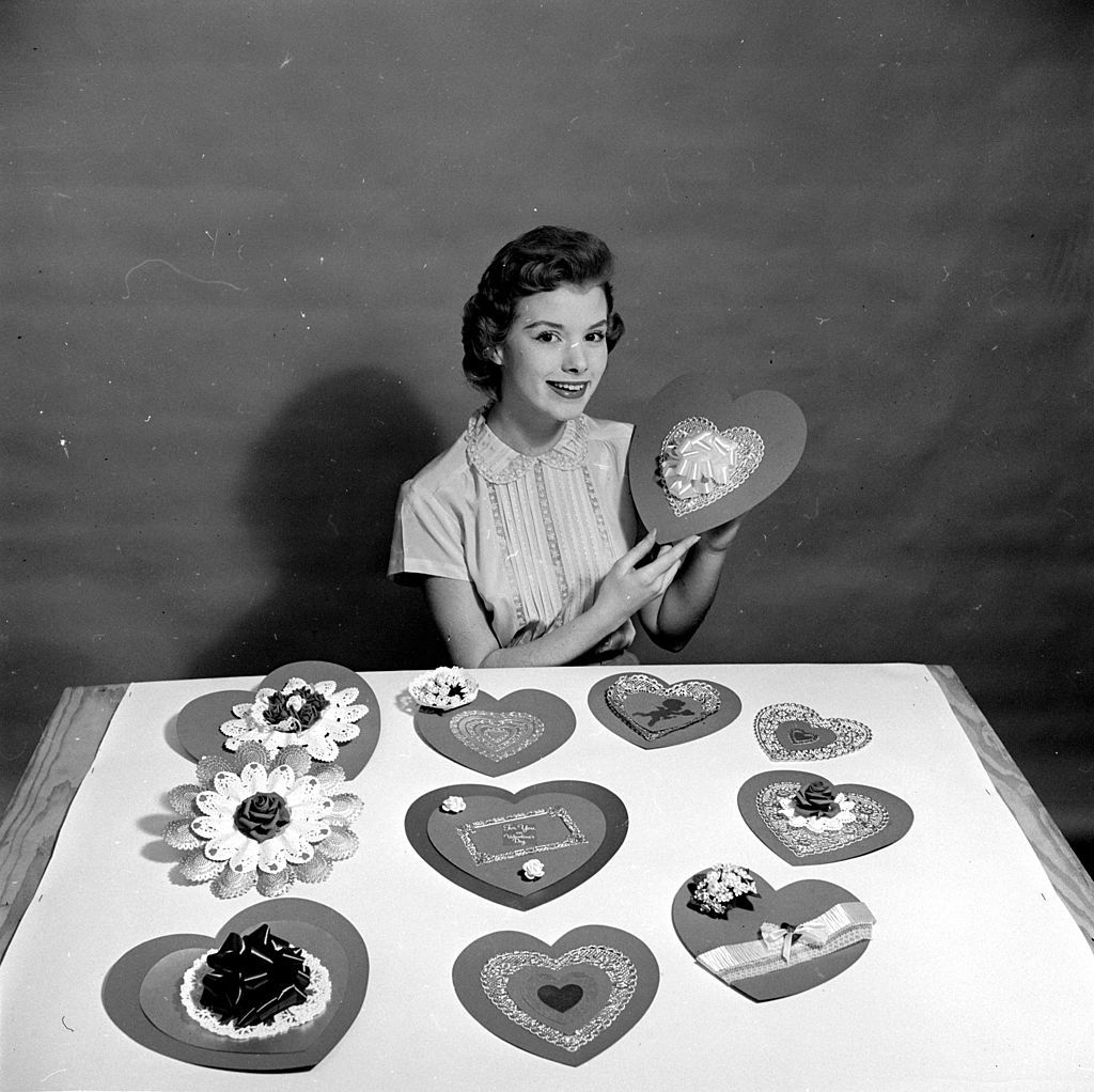 circa 1950: A woman making heart-shaped home-made cards for her sweethearts on Saint Valentine's Day. (Photo by Al Barry/Three Lions/Getty Images)