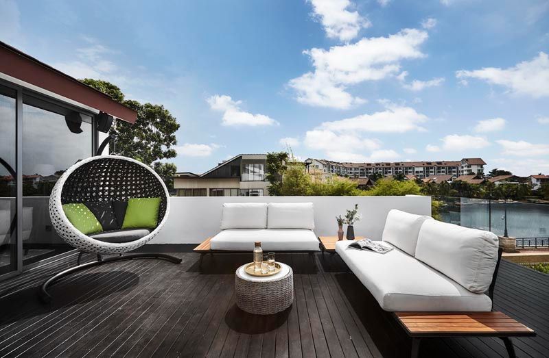Plush outdoor furniture creates a welcoming nook that invites repose on the rooftop terrace