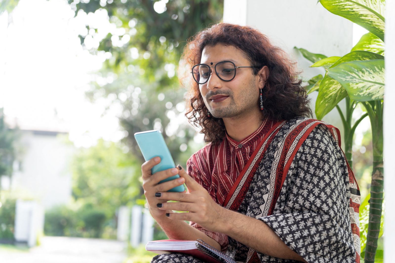 Transgender Non-Binary person using a mobile phone in an educational institute. (Photo: Getty Images)
