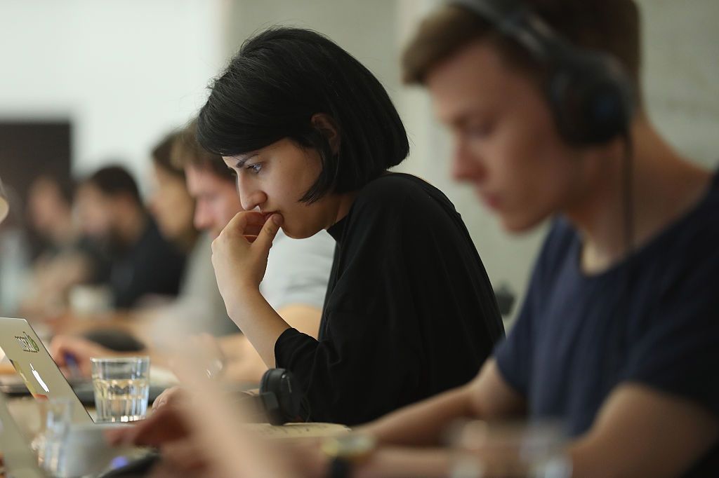 BERLIN, GERMANY - JULY 14: People work at computers in the community space of Factory Berlin on July 14, 2016 in Berlin, Germany. Factory Berlin is a commercial space that has sought to attract tech companies and startups and so far has rented out office space to international brands including Uber and Pinterest as well as local startup SoundCloud. It also maintains the community space, which brings together international software and app developers in a work environment meant to foster common creativity.