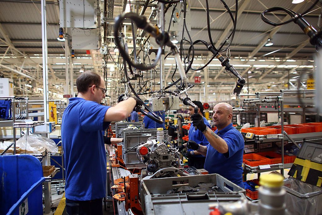 DAGENHAM, ENGLAND - JANUARY 13: An employee works on an engine production line at a Ford factory on January 13, 2015 in Dagenham, England. Originally opened in 1931, the Ford factory has unveiled a state of the art GBP475 million production line that will start manufacturing the new low-emission, Ford diesel engines from this November this will generate more than 300 new jobs, Ford currently employs around 3000 at the plant in Dagenham. (Photo by Carl Court/Getty Images)