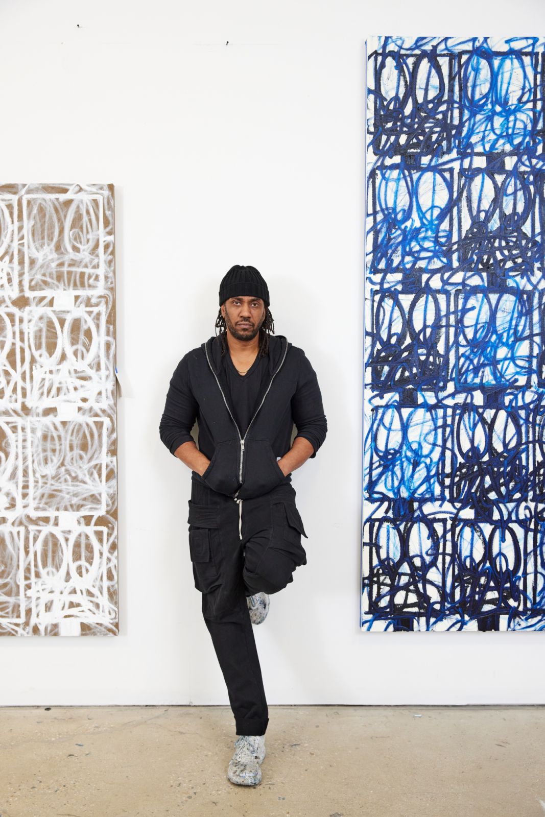 Rashid Johnson in his Brooklyn studio, standing between paintings from his Surrender and Bruise series (Photo: Masato Onoda)