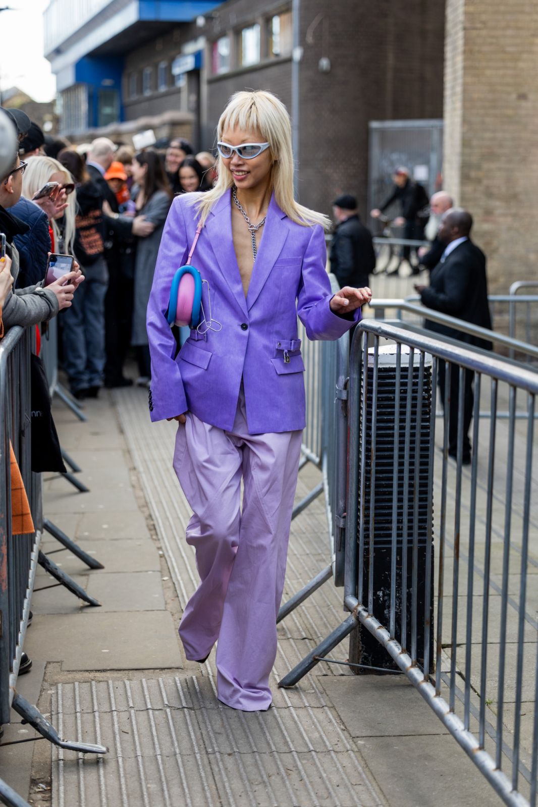 LONDON, ENGLAND - FEBRUARY 19: Vanessa Hong wears purple blazer, rose pants, bag, sunglasses outside JW Anderson during London Fashion Week February 2023 on February 19, 2023 in London, England. (Photo by Christian Vierig/Getty Images)