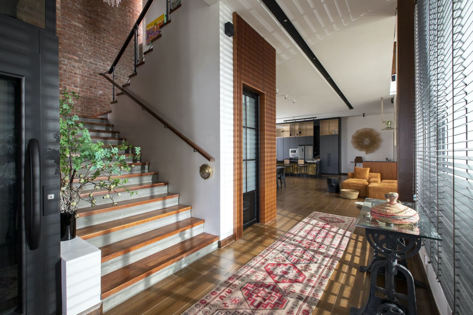Exposed brick and warm wood imbue the living with a sense of coziness