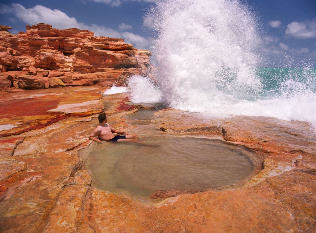 NORTH WEST AUSTRALIA - OCTOBER 2005: A man bathing in a sea water pool formed by erosion in the rocks at Broome, close to Cable Beach. (Photo by Tom Stoddart/Getty Images)
