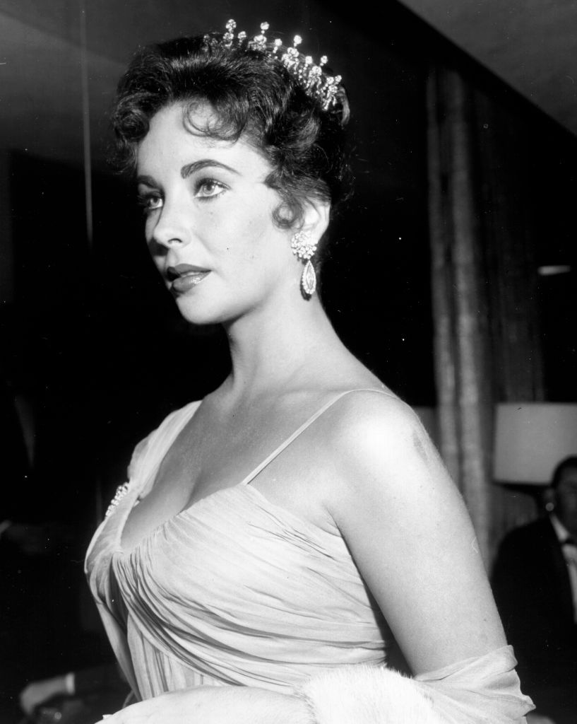 Elizabeth Taylor attends the 29th Academy Awards ceremony on March 27, 1957, in a spaghetti-strapped ruched gown and tiara from Cartier—a gift from Mike Todd. It’s because of this look that she became a fashion icon. (Photo: Getty Images / Michael Ochs Archives)