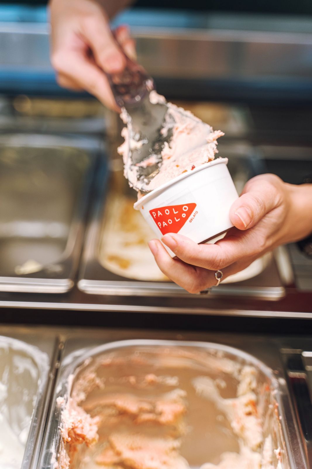 Yeoh filling up a cup with one of Paolo Paolo Gelato's most popular special flavours, peanut butter and jam toast