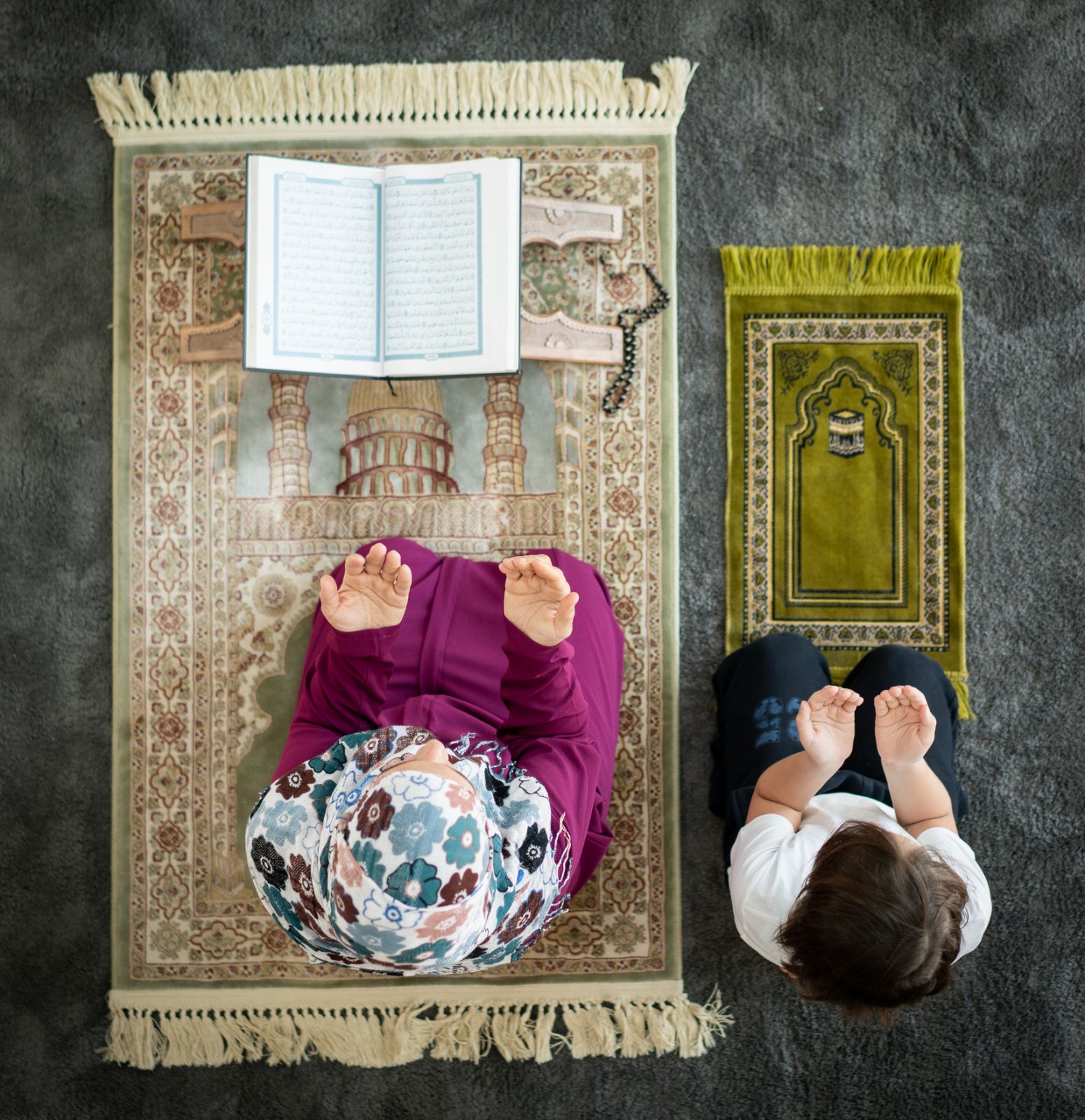 Muslim family in living room praying and reading Koran