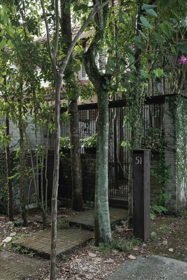 The entrance is hidden by trees