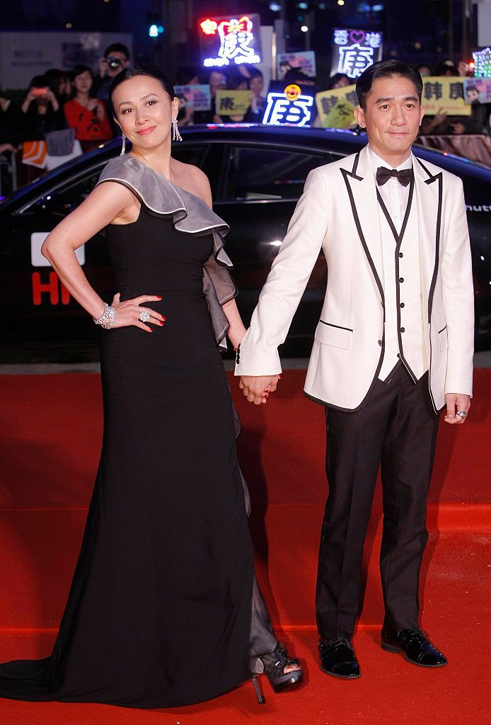 HONG KONG - MARCH 21: (CHINA OUT) Hong Kong actor Tony Leung and his wife Carina Lau attend the red carpet of the 5th Asian Film Awards at the Hong Kong Convention and Exhibition Center on March 21, 2011 in Hongkong, China. (Photo by Visual China Group via Getty Images)