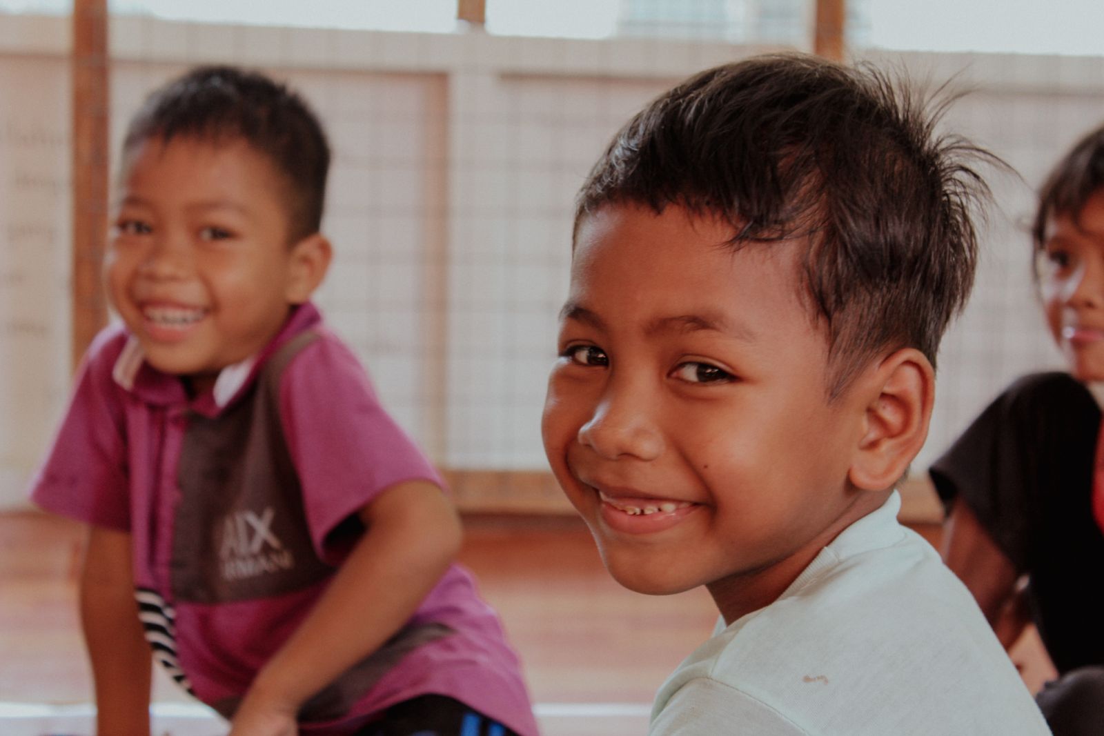 Orang Asli children smiling (Image: Daniel Fam/Unsplash)
