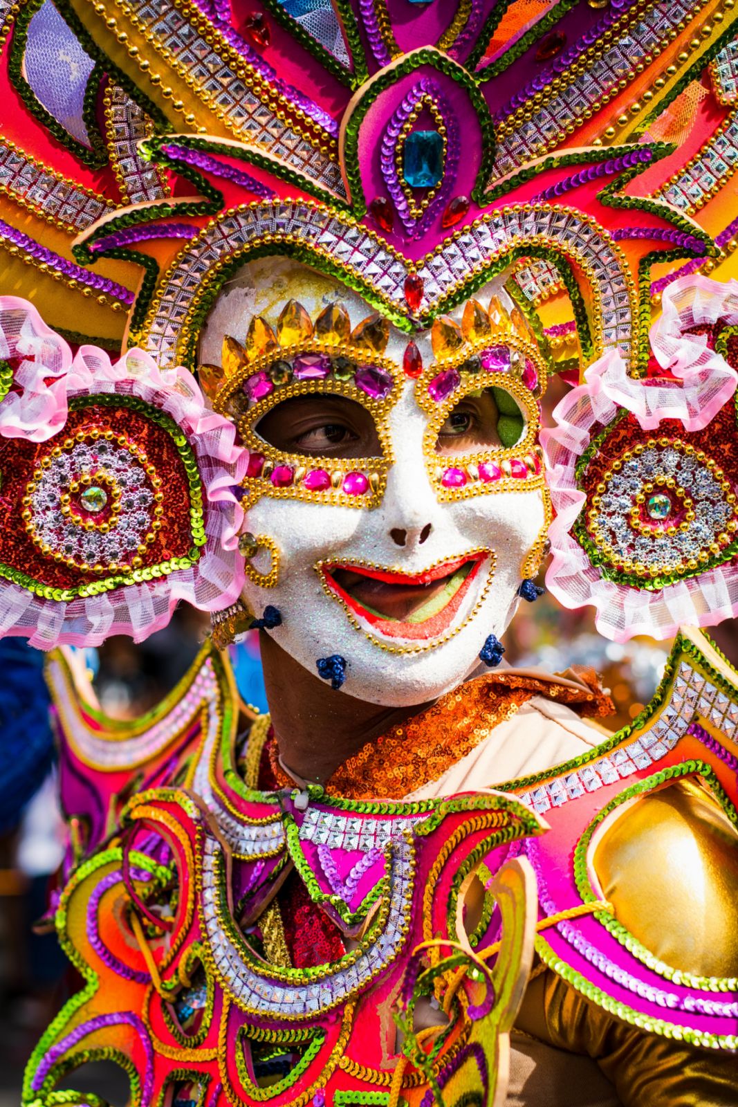 Masskara is the portmanteau of the words "mass," which means crowd, and "kara," which means face. People who joined the annual fest dance in the middle of the street wearing smiling face masks, colourful costumes, and gigantic head dresses. (Photo: Fernan Burgos/Getty Images)