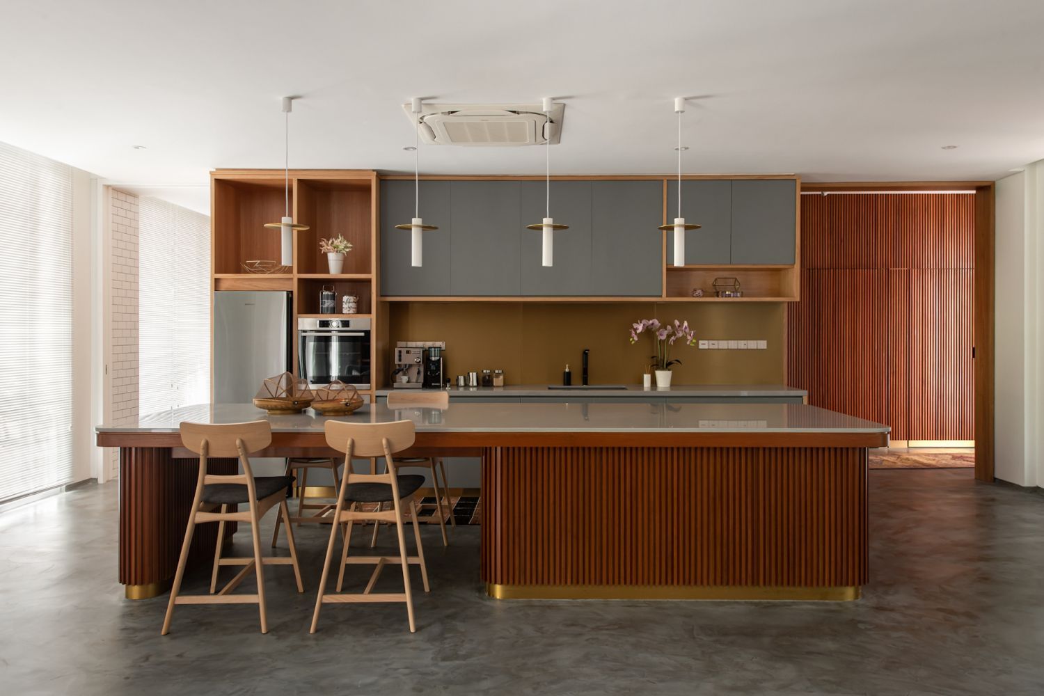 The kitchen island’s wood cladding is echoed on the walls as well (Photo: David Yeow)