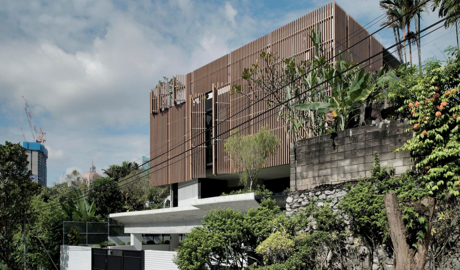 The timber cladding gives the house a distinctive facade (Photo: Rupajiwa Studio)
