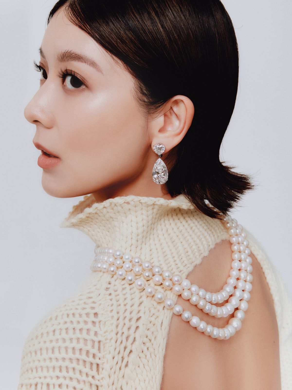 Jennifer Yu wears Harry Winston natural and cultured pearl necklace with a light pink, cushion-modified brilliant-cut 11.15-carat diamond; Bulgari earrings with pear shaped diamonds of 21.20 and 20.42 carats, heart-shaped diamonds of 4.11 and 4.07 carats (to be auctioned on May 10 and 12 at Christie’s Geneva) and Jil Sander top, available at Lane Crawford (Photo: Reuben Foong/Tatler Hong Kong)