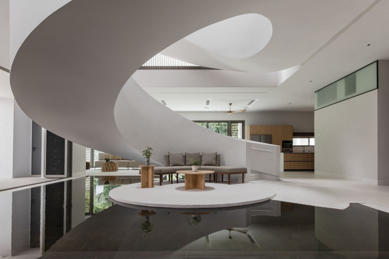 The sweeping spiral staircase with a water feature