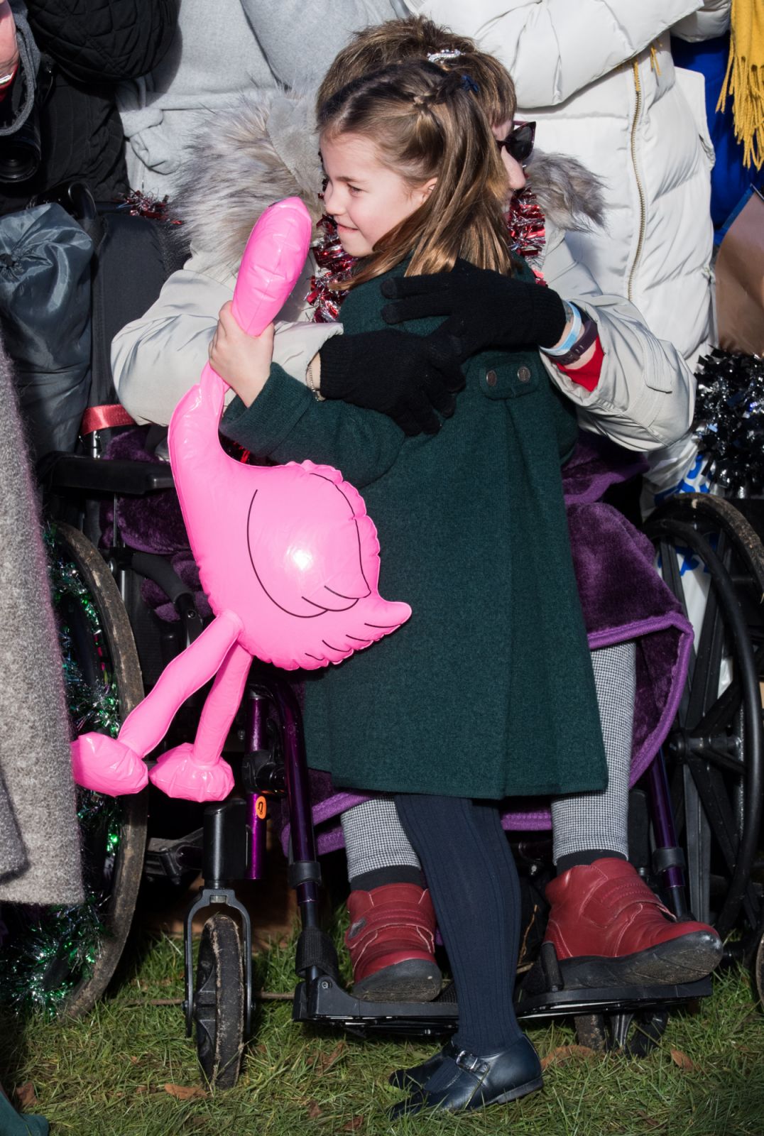 KING'S LYNN, ENGLAND - DECEMBER 25: Princess Charlotte of Cambridge is given a hug by a wellwisher as she attends the Christmas Day Church service at Church of St Mary Magdalene on the Sandringham estate on December 25, 2019 in King's Lynn, United Kingdom. (Photo by Pool/Samir Hussein/WireImage)