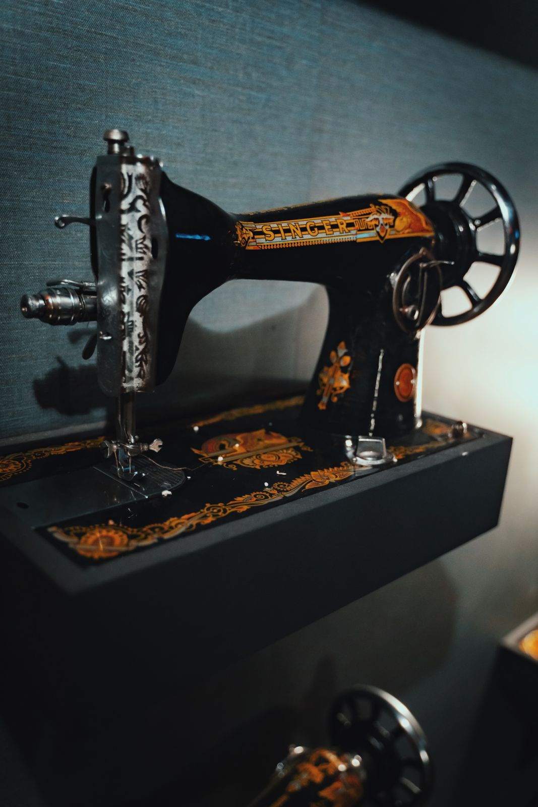 The bar is adorned with sewing motifs like this vintage sewing machine