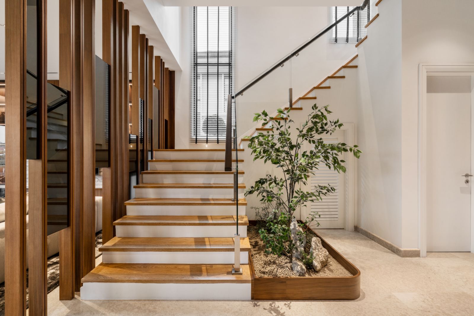 The tree grows in the central staircase
