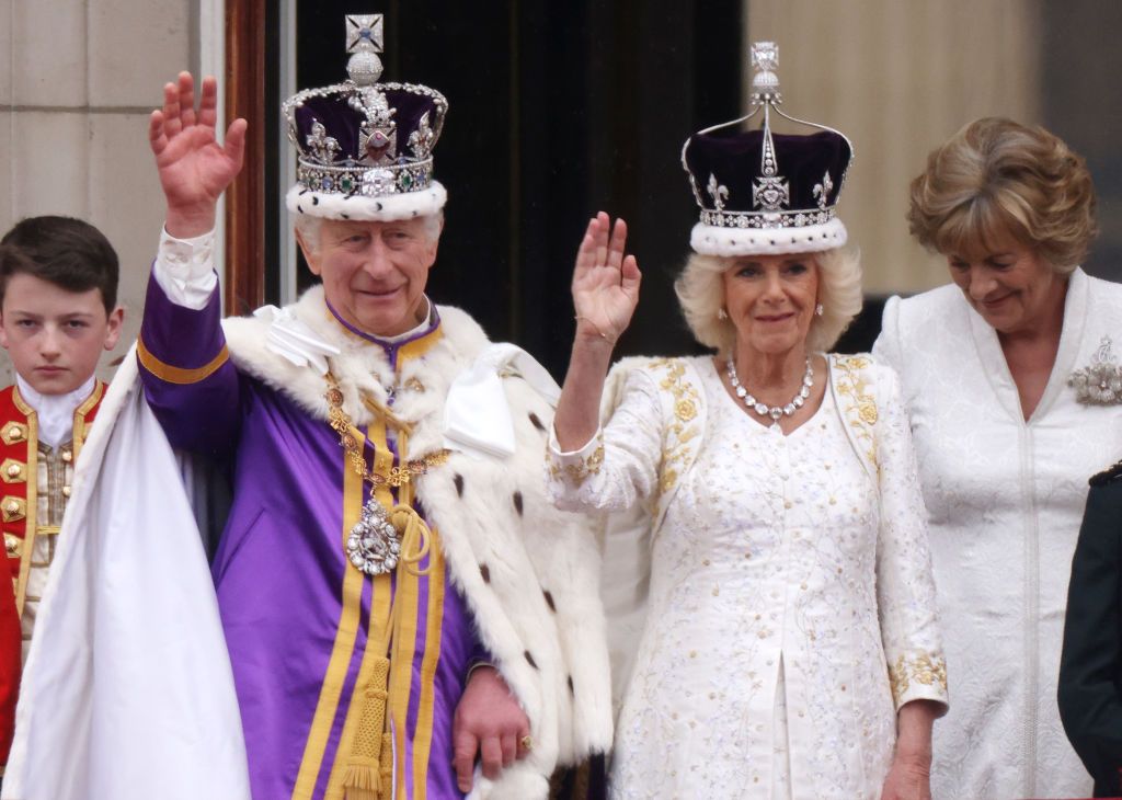LONDON, ENGLAND - MAY 06: King Charles III and Queen Camilla can be seen on the Buckingham Palace balcony ahead of the flypast during the Coronation of King Charles III and Queen Camilla on May 06, 2023 in London, England. The Coronation of Charles III and his wife, Camilla, as King and Queen of the United Kingdom of Great Britain and Northern Ireland, and the other Commonwealth realms takes place at Westminster Abbey today. Charles acceded to the throne on 8 September 2022, upon the death of his mother, El
