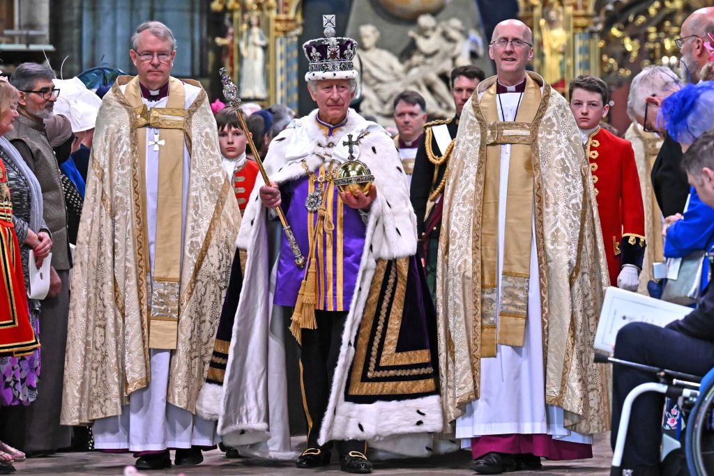 LONDON, ENGLAND - MAY 06: Britain's King Charles III wearing the Imperial state Crown carrying the Sovereign's Orb and Sceptre leaves Westminster Abbey after the Coronation Ceremonies on May 6, 2023 in London, England. The Coronation of Charles III and his wife, Camilla, as King and Queen of the United Kingdom of Great Britain and Northern Ireland, and the other Commonwealth realms takes place at Westminster Abbey today. Charles acceded to the throne on 8 September 2022, upon the death of his mother, Elizab