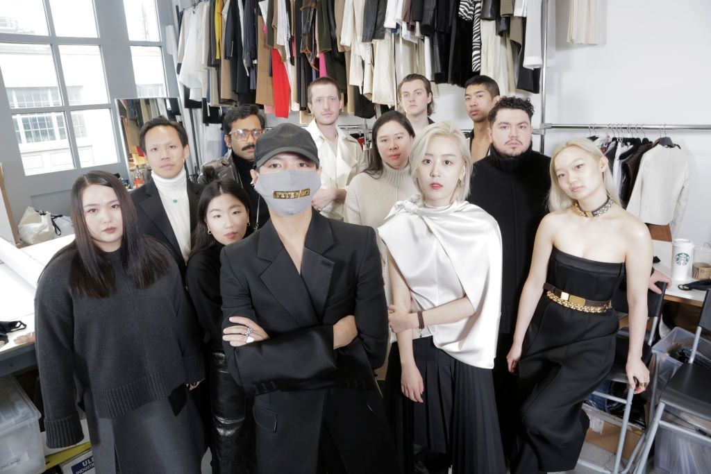 Portrait of Vietnamese-born fashion designer Peter Do (front row, back to camera) with members of his team, 2020. Pictured are, front row, from left, Bebe Bolortoli, So Hyun An, Do, Yiru Wang, and Jessica Wu; middle row, from left, An Nguyen, Utkarsh Shukla, Lydia Sukato, and Pablo Correa, back row, from left, Cooper Robar, Kellen Kauffman, and Vincent Ho. (Photo by Anthony Barboza/Getty Images)
