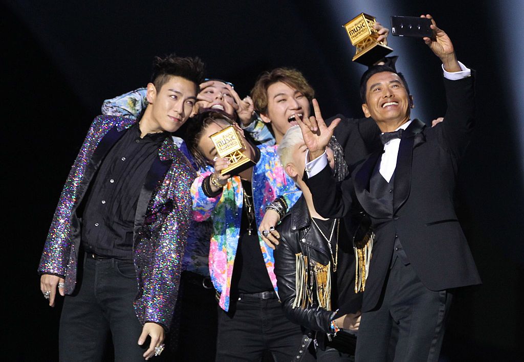 HONG KONG - DECEMBER 02: (CHINA OUT) Actor Chow Yun-fat takes a selfie with Big Bang on the stage during the 2015 Mnet Asian Music Awards (MAMA) at AsiaWorld-Expo on December 2, 2015 in Hong Kong, China. (Photo by Visual China Group via Getty Images/Visual China Group via Getty Images)