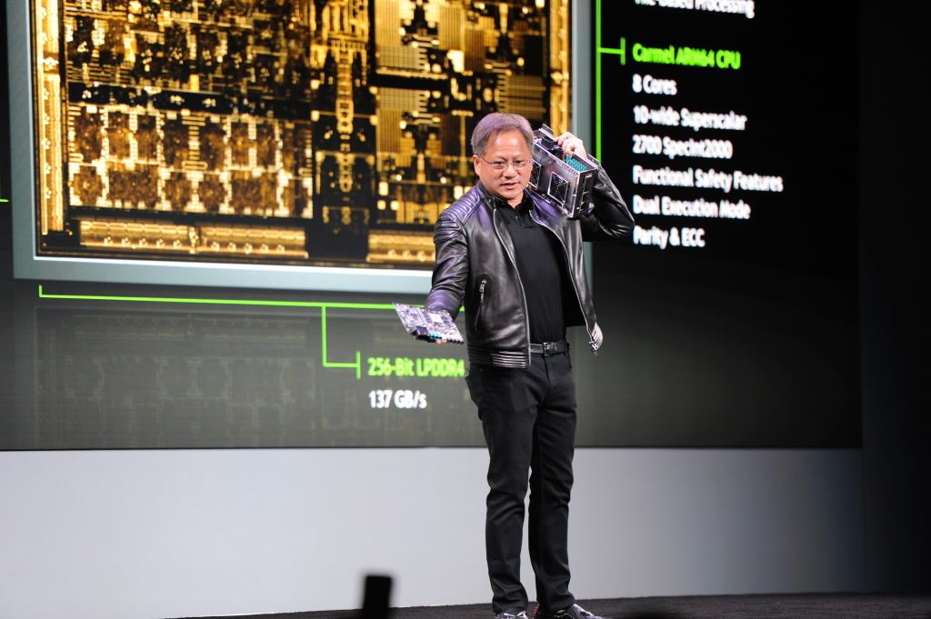 Jensen Huang, head of chip manufacturer Nvidia, shows a prototype of the new chip called 'Drive Xavier' for autonomous driving during the technological fair CESÂ 2018 in Las Vegas, USA, 8 January 2018. Photo: Andrej Sokolow/dpa (Photo by Andrej Sokolow/picture alliance via Getty Images)