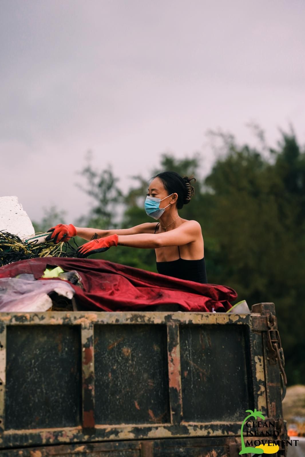 Darsea Liu putting a full trash bag into a truck (Photo: courtesy of Darsea Liu)