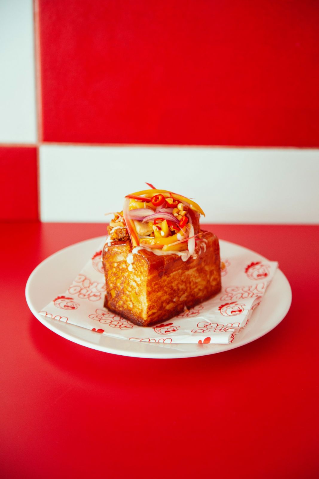 Fowlboys' Super Ring-crusted hot chicken bun with mango kerabu